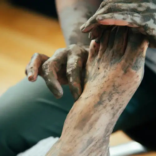 Brown and tan clay hand sculpture