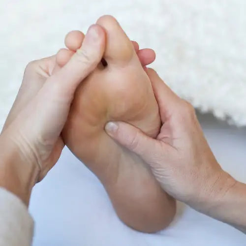 Brown leather foot massager with textured surface for grip and comfort.