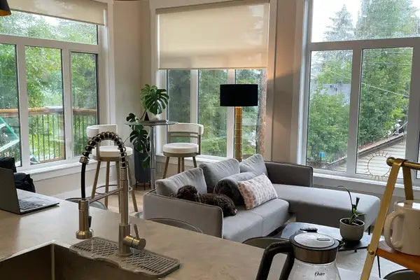 Gray sectional sofa with plush cushions and a patterned throw pillow