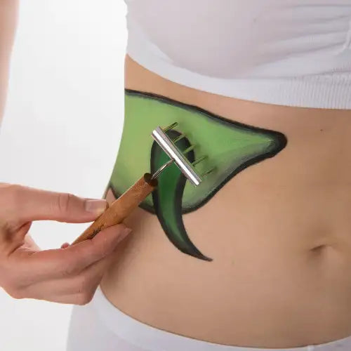 Green leaf-shaped body brush with wooden handle and metal bristles, designed for exfoliation.