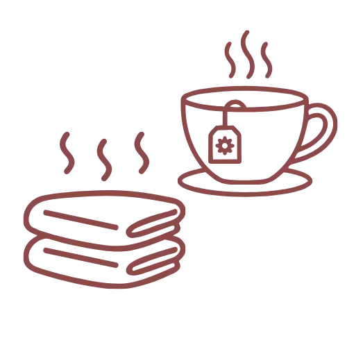 A steaming red teacup with a tea bag and saucer, alongside a stack of pancakes.
