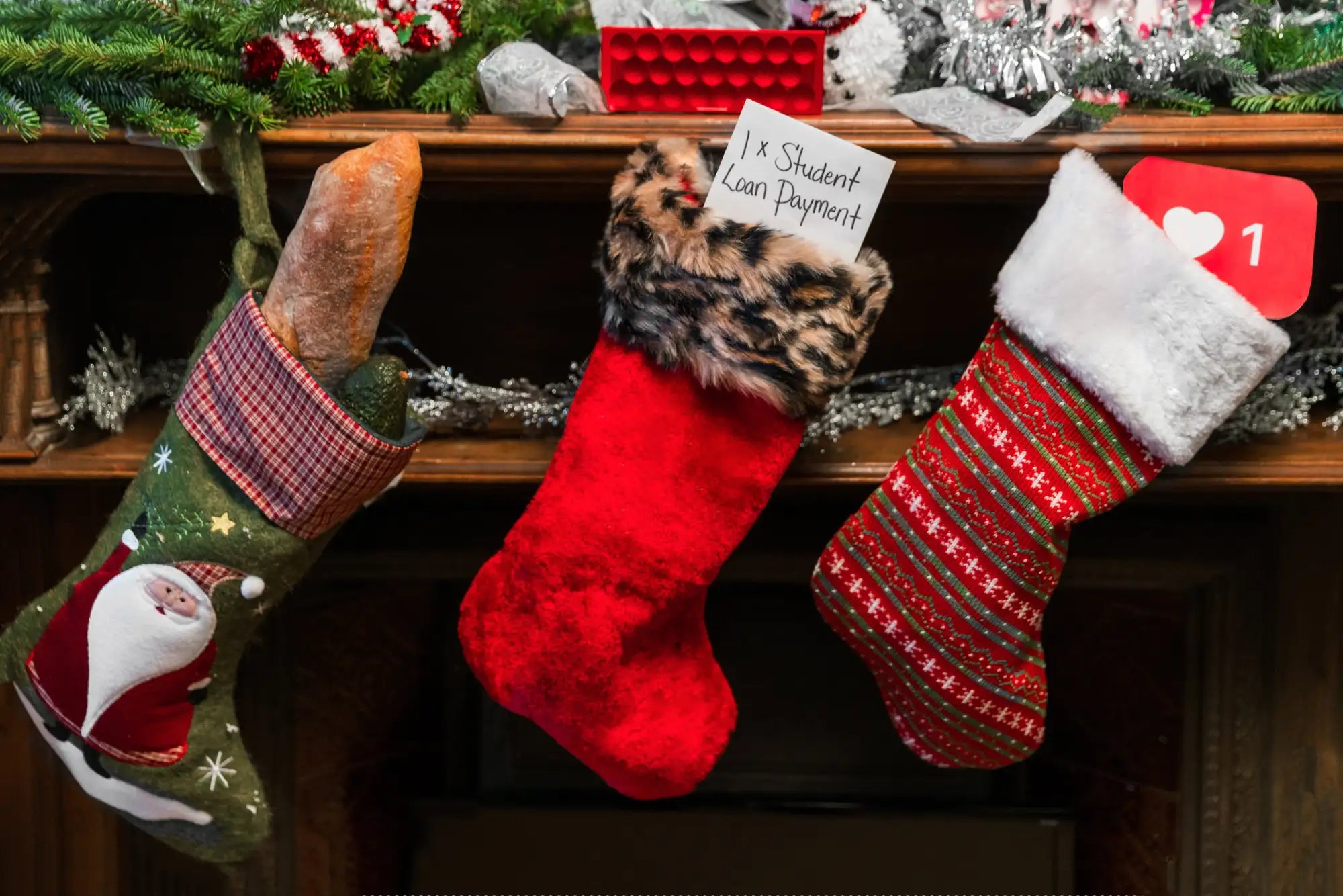 Three festive christmas stockings hang from a mantel, featuring embroidered santa designs on one green stocking with red plaid trim and fur cuff, a solid plush red velvet stocking with leopard-printed furry top, and another striped red-and-green patterned stocking adorned