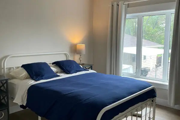 White metal bed frame with curved headboard and footboard