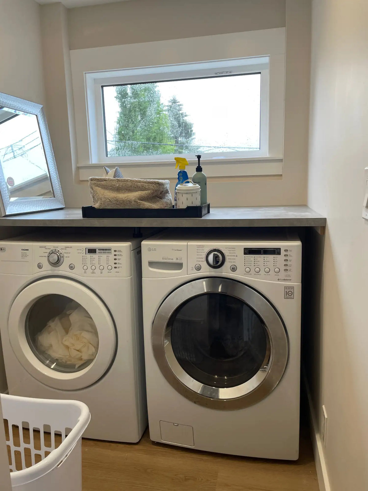 White front-loading washer and dryer set with stainless steel circular doors.